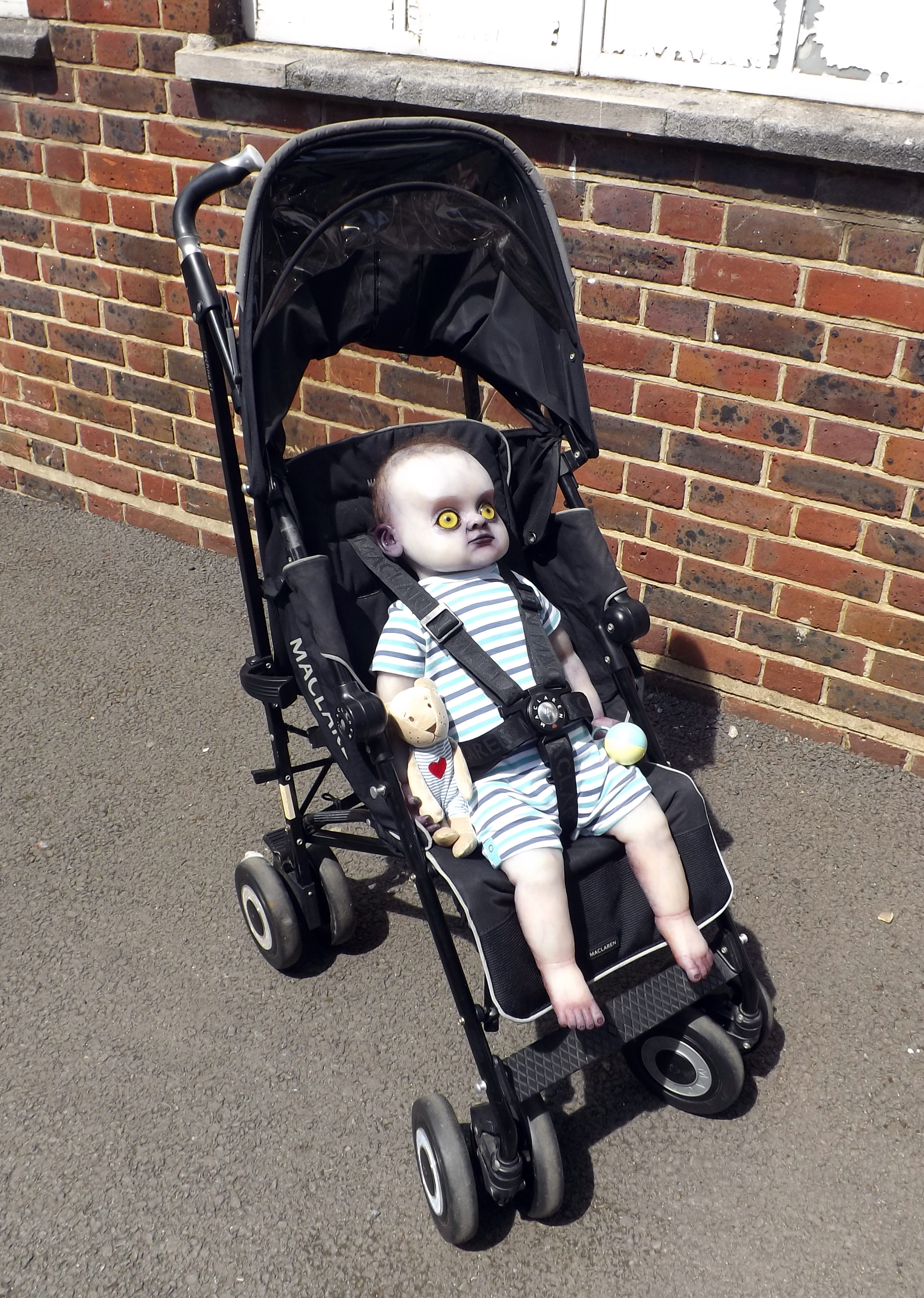 Finished and dressed full body changeling baby prop in push chair