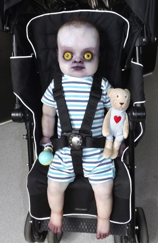 Finished and dressed full body changeling baby prop in push chair